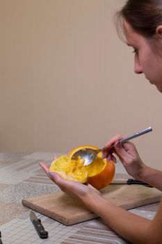 the process of making a Halloween pumpkin. cleansing of seeds. horror theme and Hallowe'en.