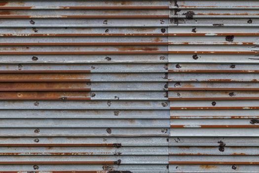 rusted corrugated steel sheets with leftovers of zync plating background and texture.