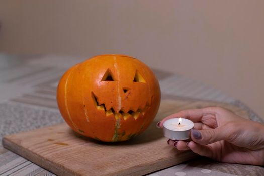 the process of making a Halloween pumpkin. lighted candle. horror theme and Hallowe'en.