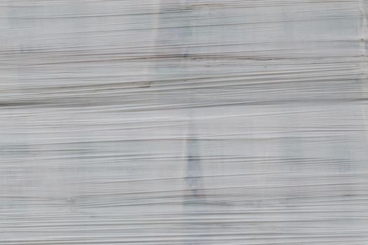 white shrink wrap film with horizontal folds - full frame background and flat texture.