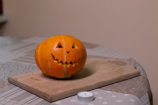 the process of making a Halloween pumpkin. lighted candle. horror theme and Hallowe'en.