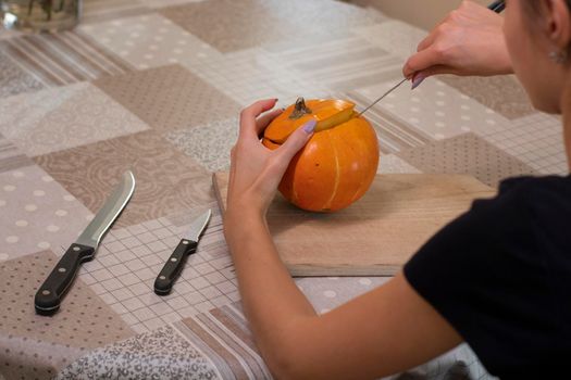 the process of making a Halloween pumpkin. cleansing of seeds. horror theme and Hallowe'en.