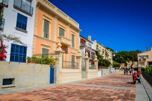 Blue sky, baroque architecture and Mediterrenean flowers on city street.