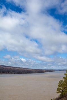 A beautiful, wide river in the spring among the forests. Quiet and peaceful place. Not clear, muddy water in the river. Top view of the distance