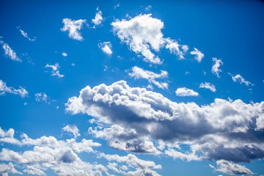 Big white clouds in a blue sky close-up. There is a place for the text. The concept of cleanliness in nature and caring for nature