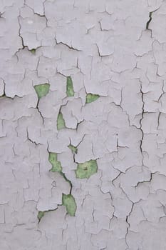 Old cracked paint on wall. Texture, pattern, background. wall cracked with paint, abstract paint behind the iron. close up