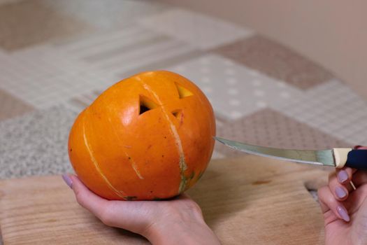 the process of making a Halloween pumpkin. cutting nose. horror theme and Hallowe'en.