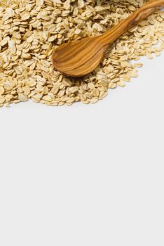 Oat flakes with wooden spoon isolated on white background. healthy, dieting food concept