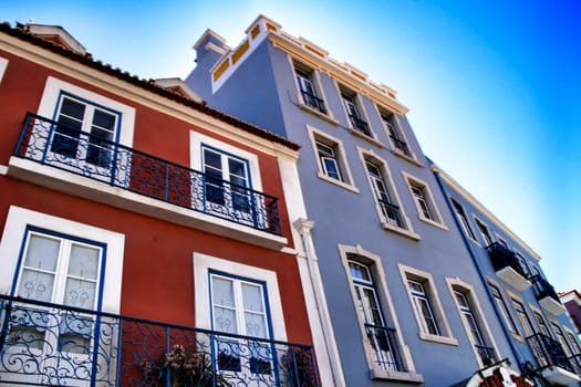 Old colorful houses and streets of Lisbon, Portugal in Spring. Majestic facades and old street lights.