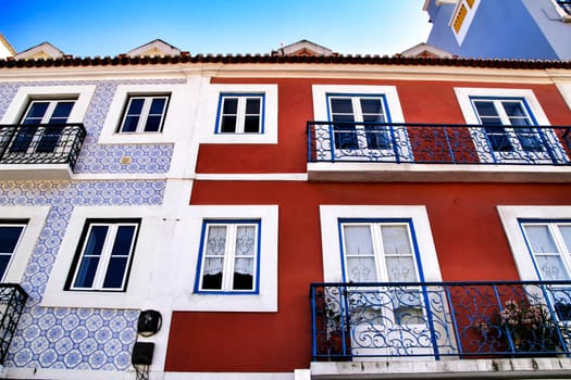 Old colorful houses and streets of Lisbon, Portugal in Spring. Majestic facades and old street lights.