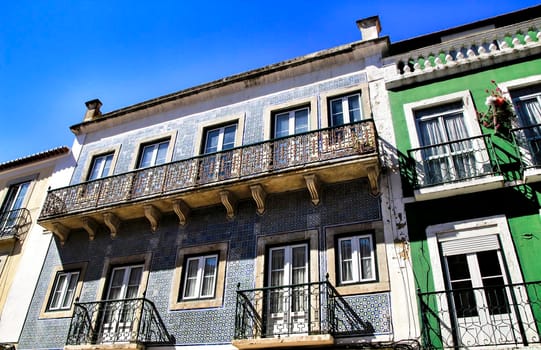 Old colorful houses and streets of Lisbon, Portugal in Spring. Majestic facades and old street lights.