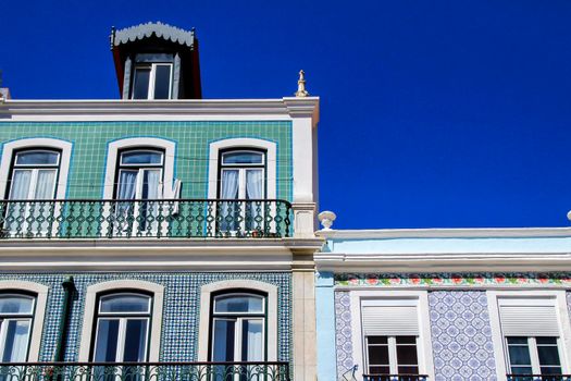 Old colorful houses and streets of Lisbon, Portugal in Spring. Majestic facades and old street lights.