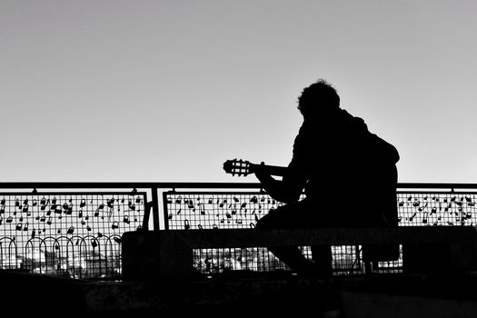 Musician playing fado music on a viewpoint in Lisbon in the morning in a sunny day of Spring
