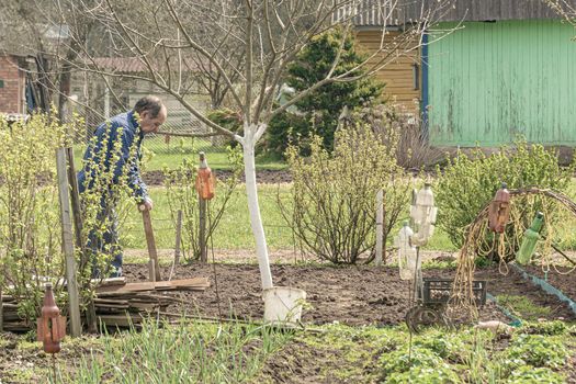 POLAND, Lomza - May 01, 2021: A farmer on a private farmstead is engaged in agricultural work. Stock photo.