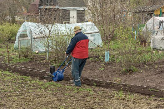 POLAND, LOMZA - May 01, 2021: A farmer on a private farmstead cultivates a plot for planting plants. Stock photo.
