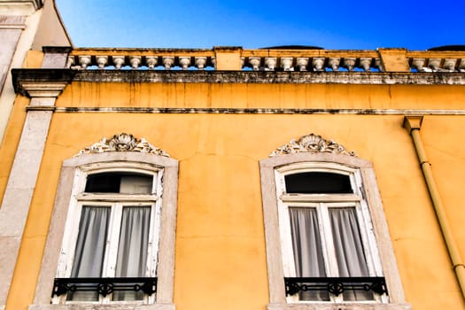 Old colorful houses and streets of Lisbon, Portugal in Spring. Majestic facades and old street lights.