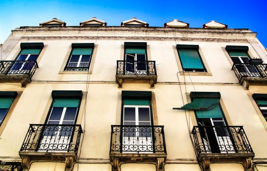 Old colorful houses and streets of Lisbon, Portugal in Spring. Majestic facades and old street lights.