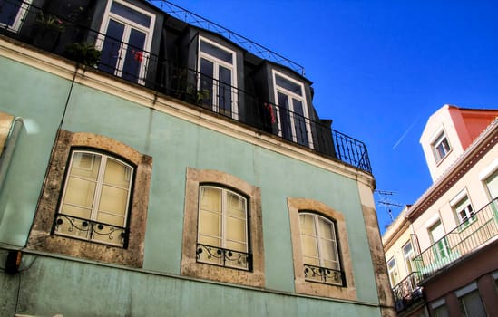 Old colorful houses and streets of Lisbon, Portugal in Spring. Majestic facades and old street lights.