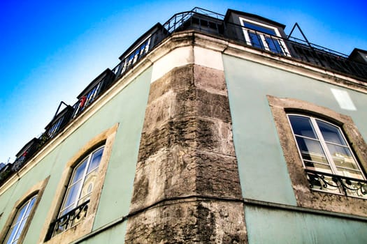 Old colorful houses and streets of Lisbon, Portugal in Spring. Majestic facades and old street lights.