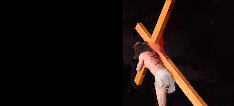 Jesus carrying the Cross into the darkness.Crucifixion of Jesus.Easter banner concept.