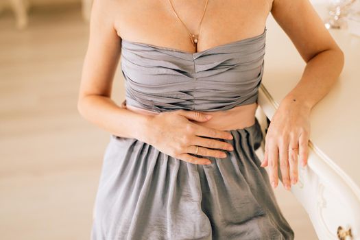 Her hands on pregnant belly. Studio photoshoot birth abortion