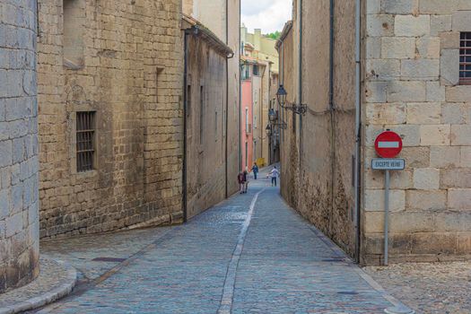 Historical part of the old town in the vicinity of the Church of St. Philip (Girona, Spain). Stock photo.