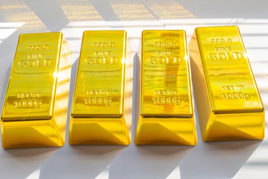 Calgary, Alberta, Canada. April 10, 2021. Several of Gold Bars or Golden Bricks Bullions on American USA currency.