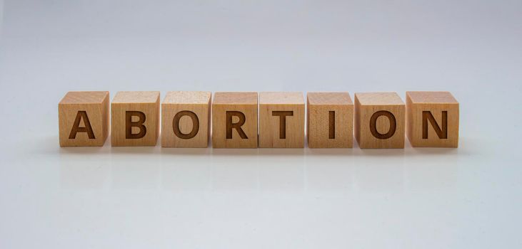 A Banner with wooden blocks with the text: "Abortion" on a clear background