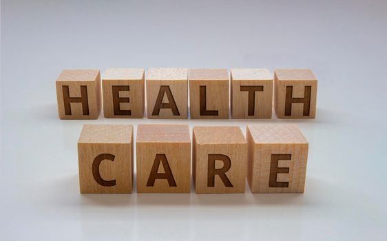 Wooden blocks with the text: "Health Care" on a clear background