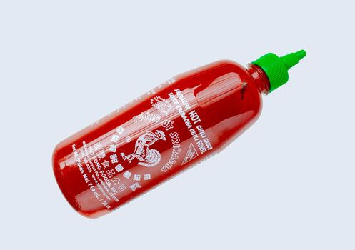 Calgary, Alberta Canada. May 7, 2021. A Sriracha hot souce bottle a type of hot sauce or chili sauce made from a paste of chili peppers, distilled vinegar, garlic, sugar, and salt.