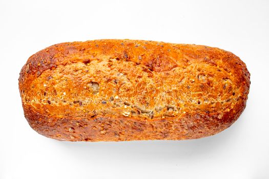 Top view of a Bakery Artisan Bread, Harvest Grain Oval on a white table.