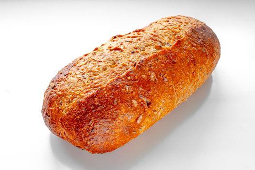Front view of a Bakery Artisan Bread, Harvest Grain Oval on a white table.