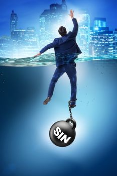 Businessman drowning under the burden of sin and guilt