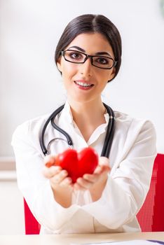 Young doctor in heart care concept