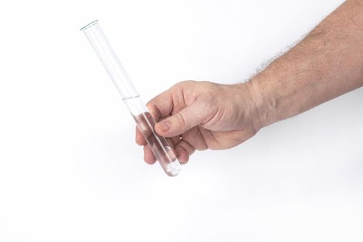 Hand holds a glass test tube with a transparent liquid on a white background, a template for designers. Close-up