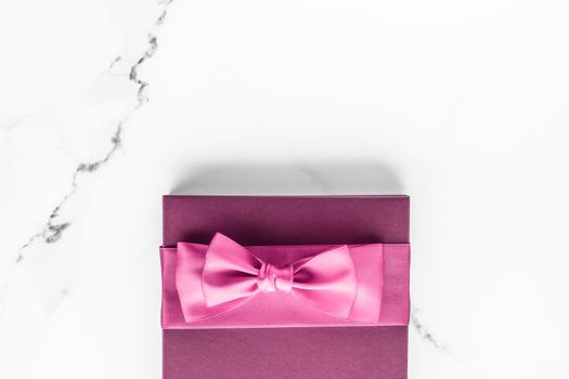 Birthday, wedding and girly branding concept - Pink gift box with silk bow on marble background, girl baby shower present and glamour fashion gift for luxury beauty brand, holiday flatlay art design