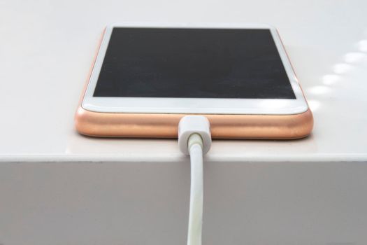 A smart phone changing on a white table