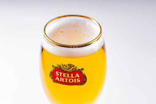 Close up of a cups of Stella Artois full of beer on a white background