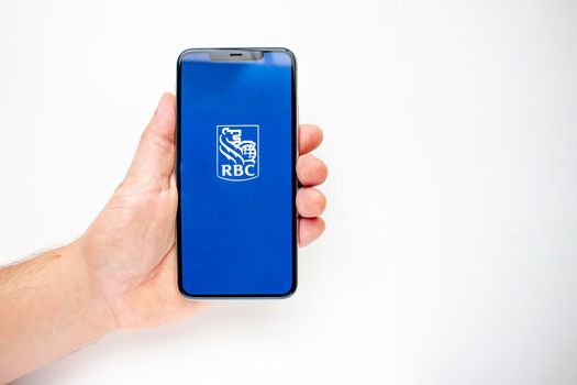 Calgary, Alberta, Canada. Aug 15, 2020. A person holding an iPhone 11 Pro Max with the RBC App