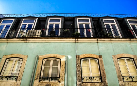 Old colorful houses and streets of Lisbon, Portugal in Spring. Majestic facades and old street lights.