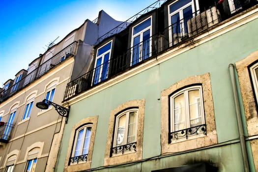 Old colorful houses and streets of Lisbon, Portugal in Spring. Majestic facades and old street lights.