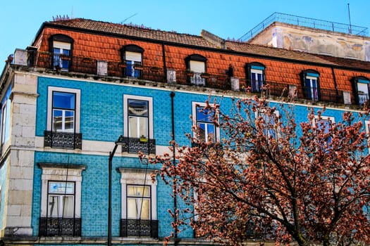 Old colorful houses and streets of Lisbon, Portugal in Spring. Majestic facades and old street lights.