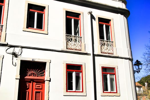 Old colorful houses and streets of Lisbon, Portugal in Spring. Majestic facades and old street lights.