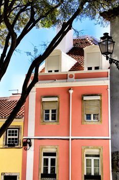 Old colorful and beautiful facades with vintage streetlight in Lisbon streets in Spring.