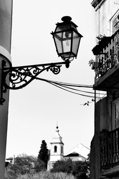 Old colorful and beautiful facades with vintage streetlight in Lisbon streets in Spring.