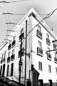 Old colorful and beautiful facades with vintage streetlight in Lisbon streets in Spring.