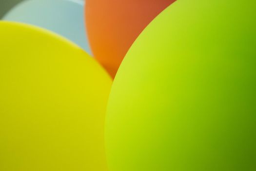 Balloons of colors grouped, green, pink, yellow, orange, pink. No people