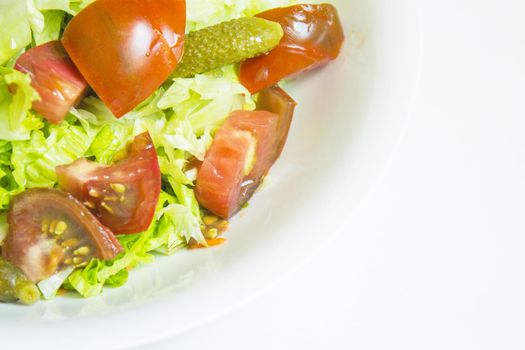 Lettuce salad with tomato and pickles. Raw food
