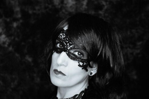 Woman disguised in gothic style for halloween party with mask