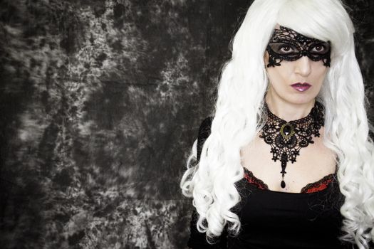 Woman disguised in gothic style for halloween party with mask